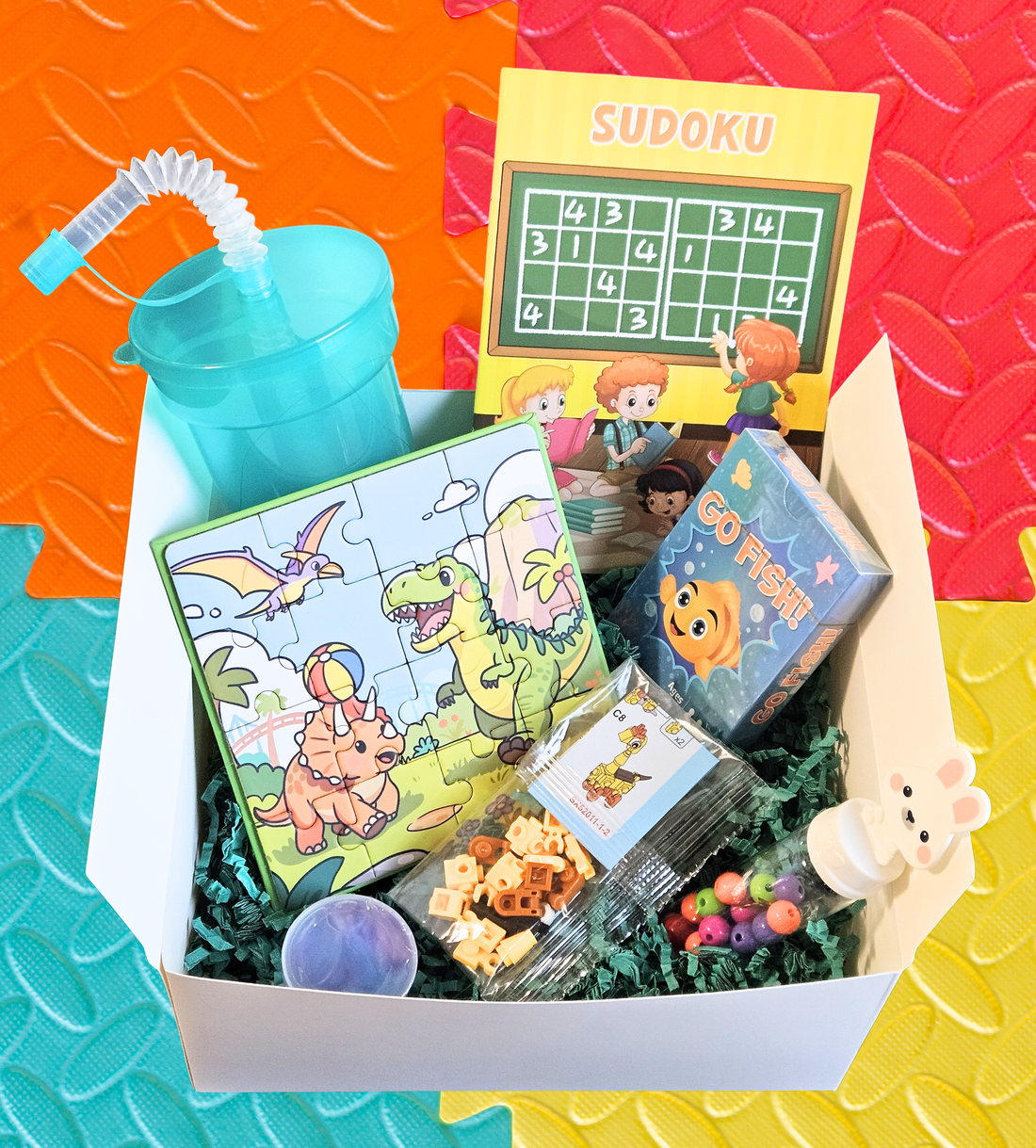 Kids Fun Pack gift box with activity book, magnet puzzle, Go Fish game, mini building blocks, bracelet kit, slime, and kids tumbler