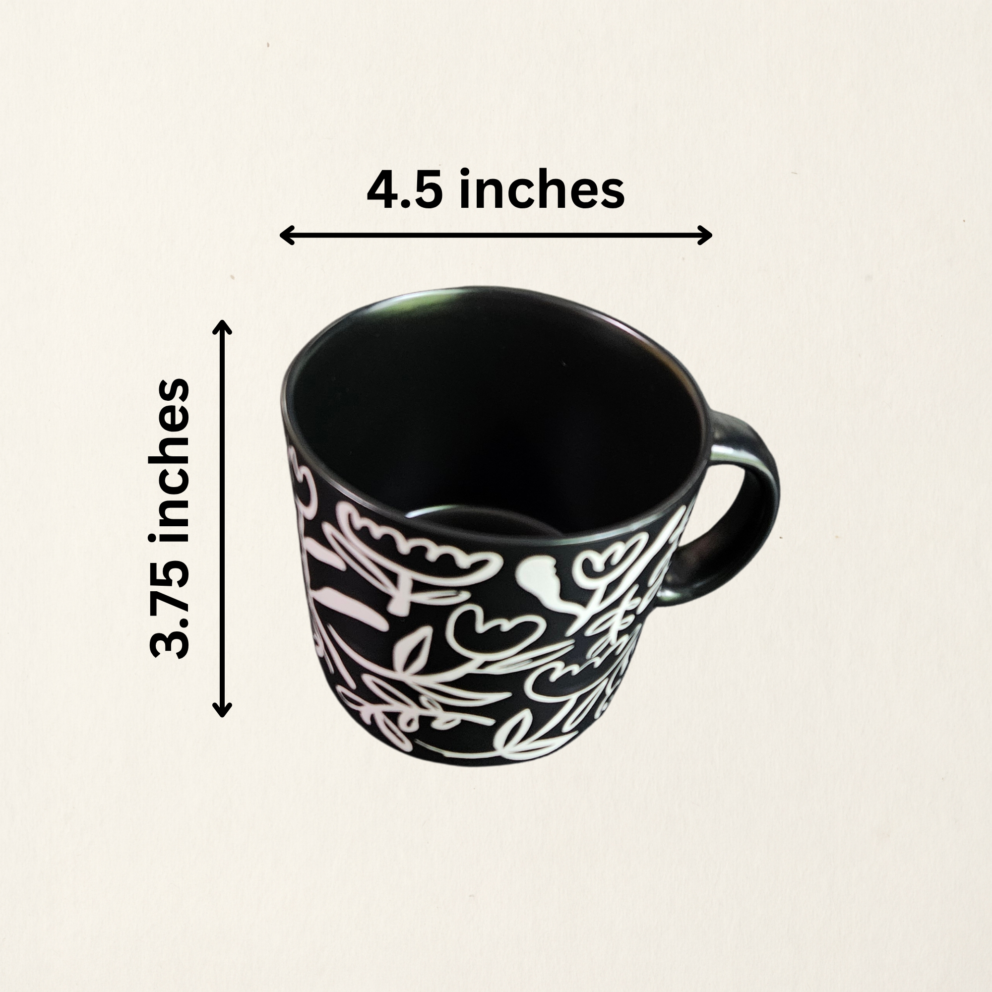 A ceramic soup mug with a modern floral design  with measurements, available in black with white flowers or white with black flowers.