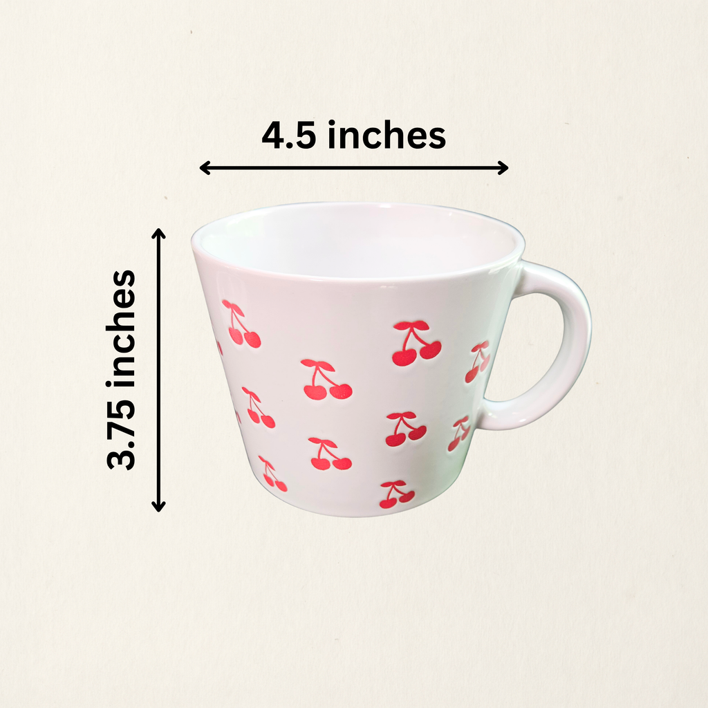 A ceramic soup mug with red cherry designs and a silicone‑sealed plastic lid featuring an adjustable dial and venting hole with measurements, available in pink or white.