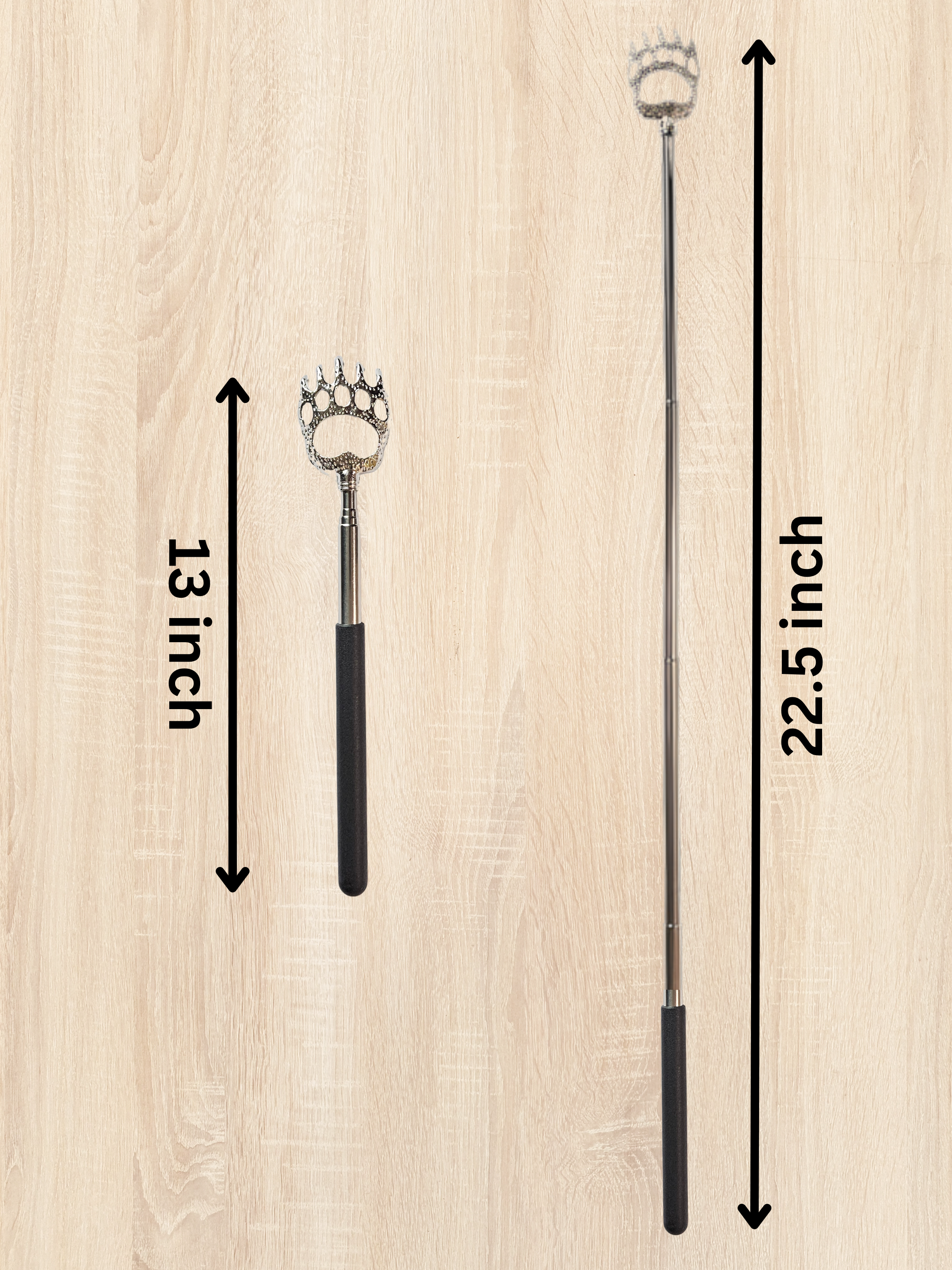 Silver extendable bear claw back scratcher with black rubber handle on a neutral background with measurements.