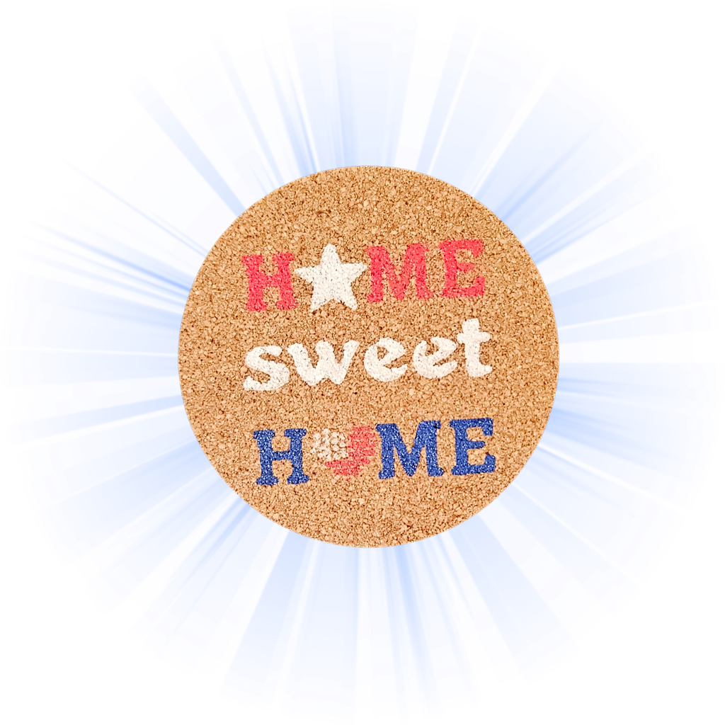 A round cork coaster with the phrase 'home sweet home' in red, white, and blue lettering, set against a white background with light blue sunburst rays.