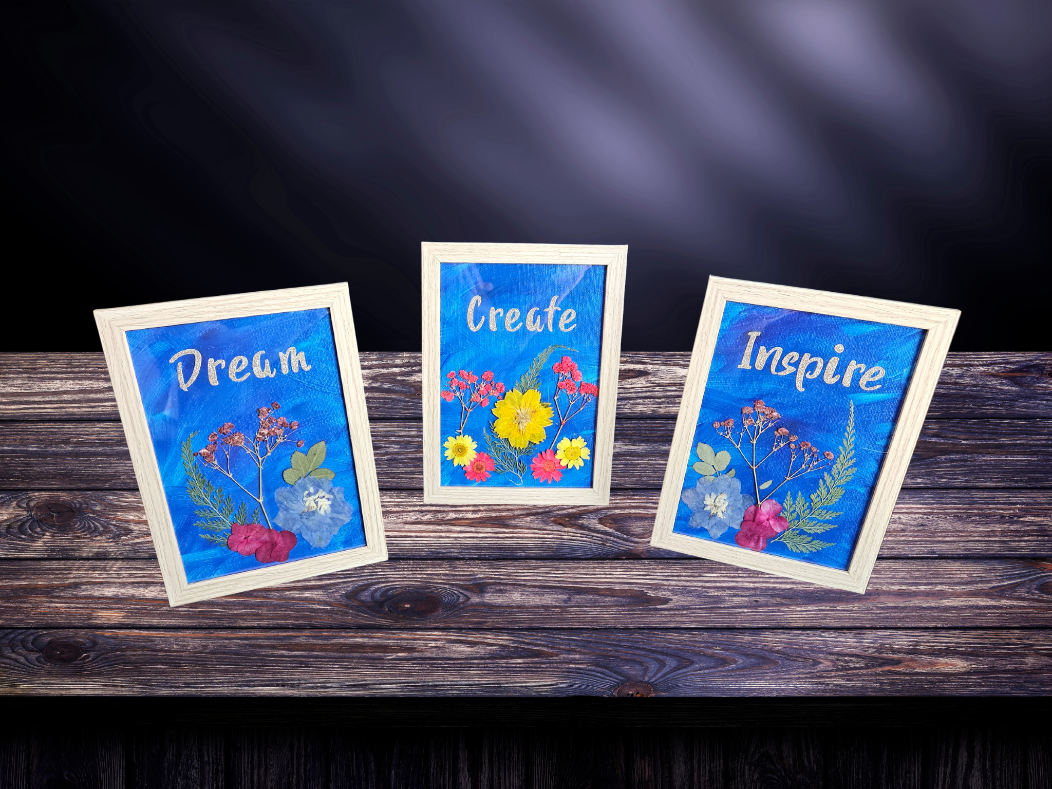 Set of three 5x7 framed art pieces with pressed flowers and the words Dream, Create, Inspire.