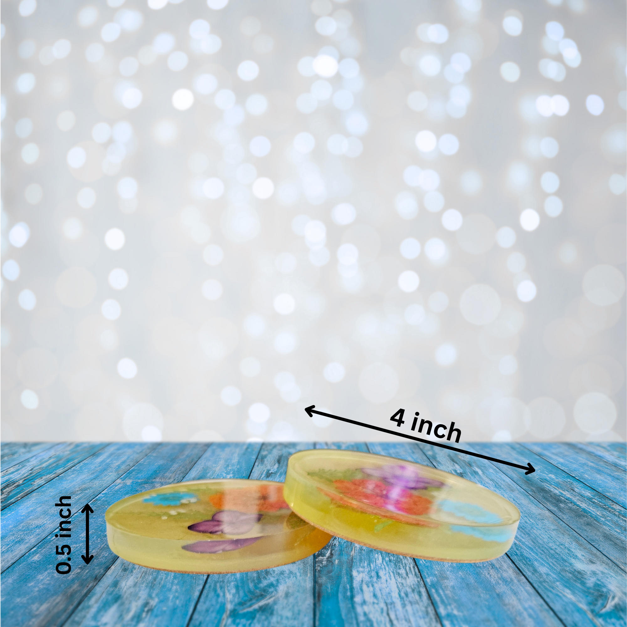 Two resin coasters with real pressed flowers in orange, blue, purple, and white on a light blue background with measurements.