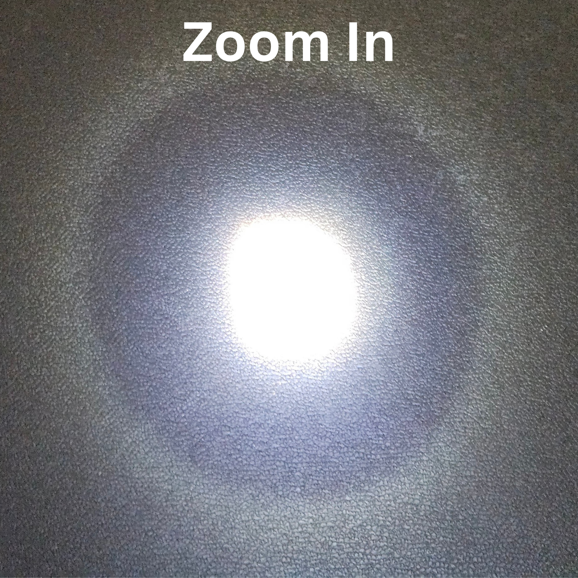 Textured dark surface with a bright light source in the center, labeled 'Zoom In'.