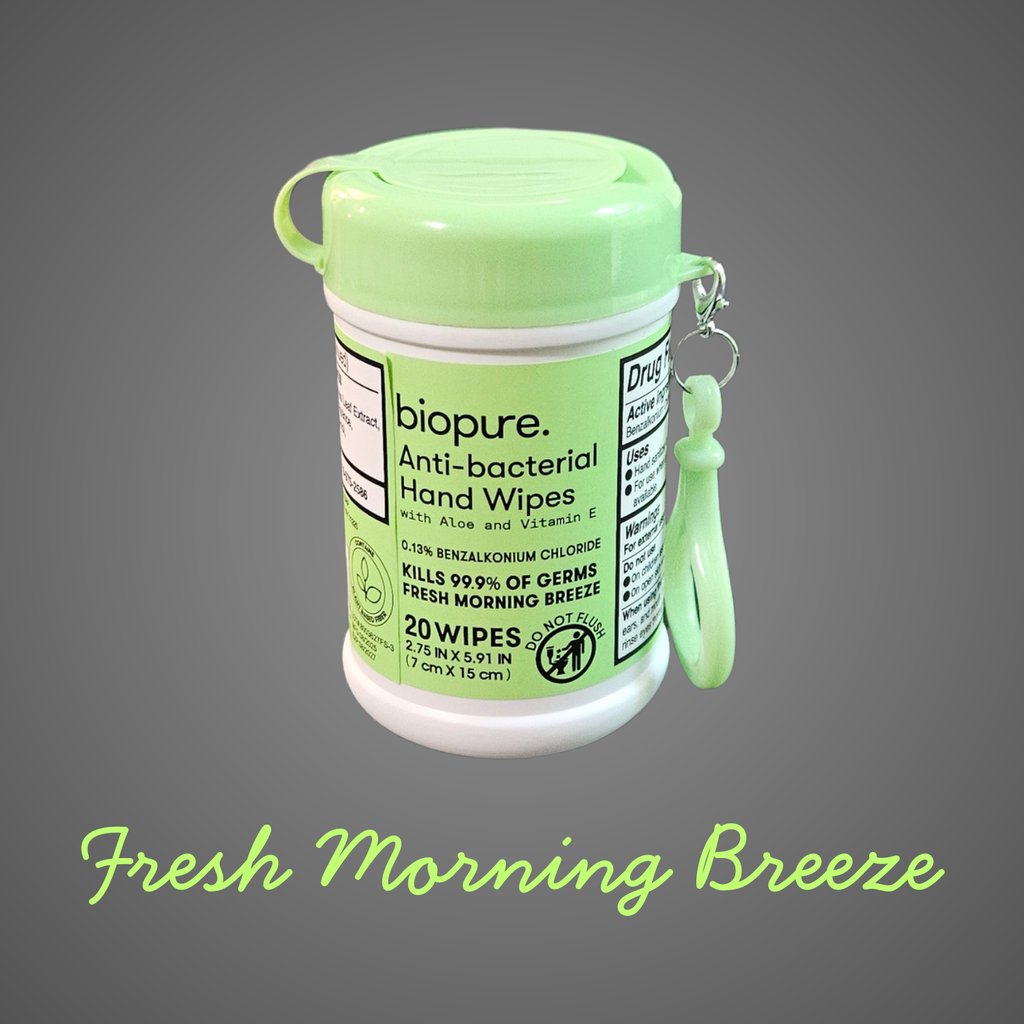 A small green-lidded container of BioPure anti-bacterial hand wipes with a matching carry clip, shown against a gray background with “Fresh Morning Breeze” written below.