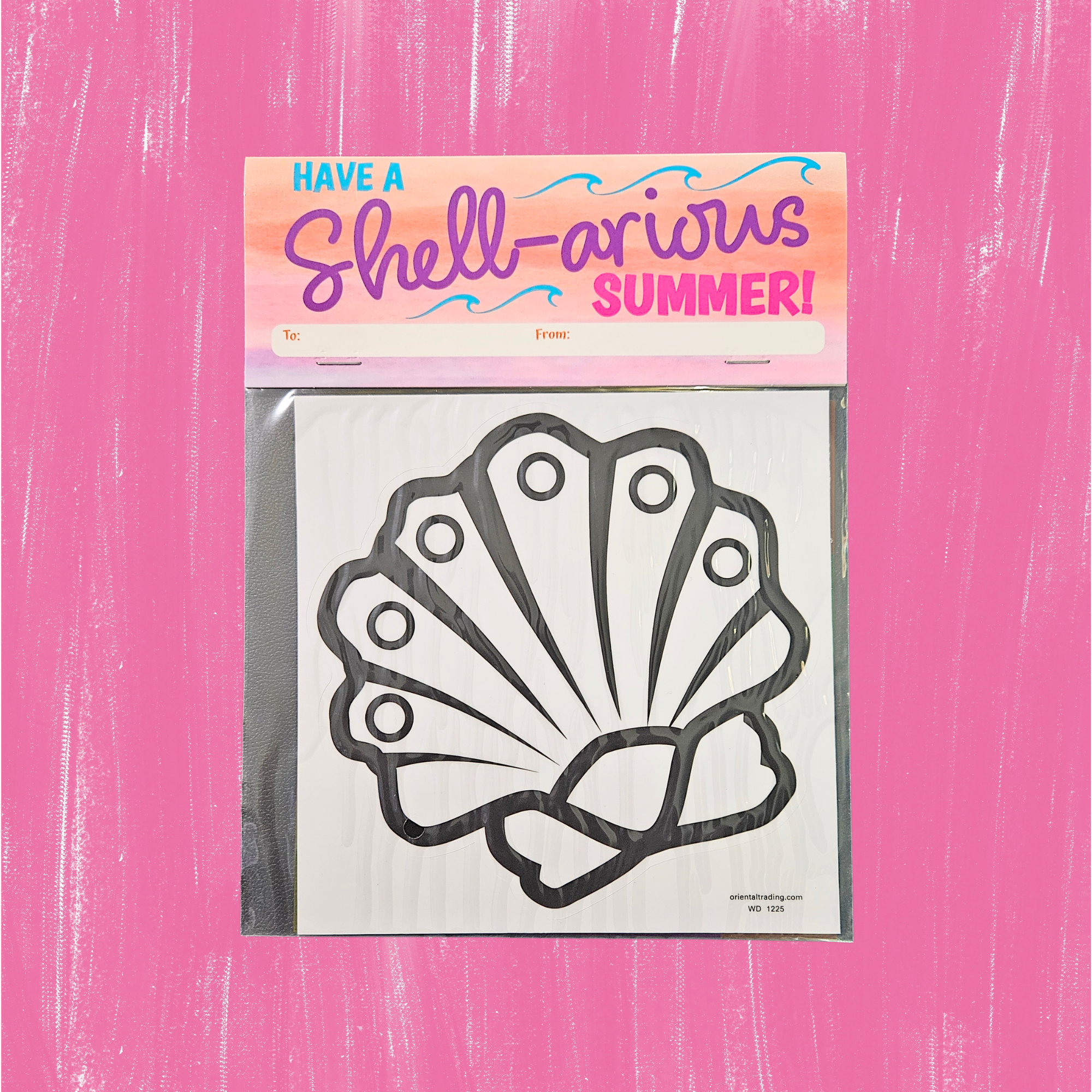 Packaged shell-shaped window cling with 'Have a Shell-arious Summer!' text on a pink background