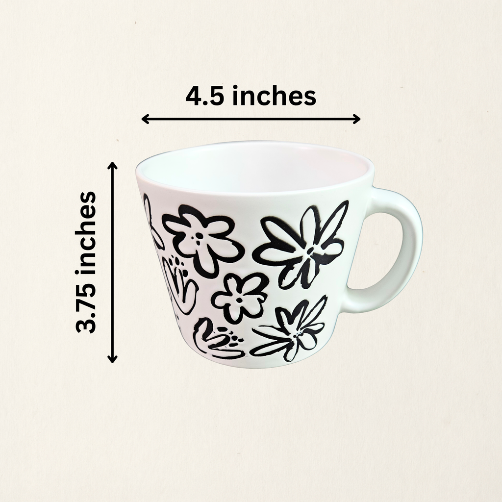 A ceramic soup mug with a modern floral design with measurements, available in black with white flowers or white with black flowers.